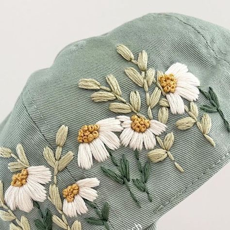 Hand Embroidery by Gaby ✨ on Instagram: "It's a sage green kinda day! ☺️🌸🌿 and my favorite flowers to stitch 😍 New hats are coming to the shop this Saturday at 5pm! #modernembroidery #embroideredhats #sagegreen #embroideredflowers #hatday #summeroutfitinspo #etsycreatorco" Hat Hand Embroidery, Sage Cottage, Needlework Ideas, Hat Day, Hat Embroidery, Embroidered Caps, Favorite Flowers, Modern Embroidery, Embroidered Hats