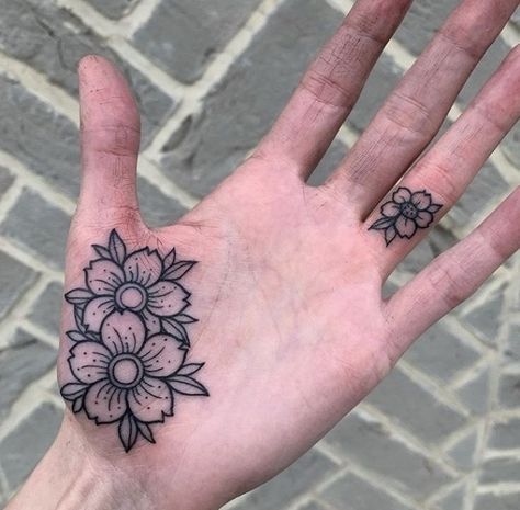 Hand tattoos are becoming more socially acceptable as we see many of our favourite celebrities wearing them.Whether it’s a full hand tattoo, a delicate finger tattoo, a beautiful wrist tattoo or a daring palm tattoo, there’s sure to be something to inspire you here! HAND TATTOO PAIN LEVELS Widely regarded as one of the more […] Read more... #sunflowertattoos #tattooforwomen Hand Palm Tattoos, Side Hand Tattoos, Thumb Tattoos, Full Hand Tattoo, Ma Tattoo, Finger Tattoo For Women, Finger Tattoo Designs, Palm Tattoos, Skeleton Hand Tattoo