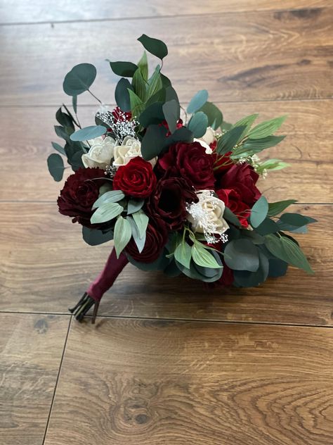 Sola wood flower bouquet with red  flowers. Preserved eucalyptus as well as artificial . Size pictured is medium. Bouquet  can also be made in small or large.MADE TO ORDER!! Each flower is hand made and painted so a slight variation in placement may occur from one bouquet to the next. Please allow 8-10 weeks for shipping. Can also add matching  bridesmaid bouquets boutonnieres and corsages per request ! Message me for custom orders For matching boutonnieres--> https://www.etsy.com/listing/740856 Eucalyptus And Red Roses, Bride Bouquets Red Roses, Homecoming Bouquets, Red Floral Arrangements, Wood Flowers Wedding, Red Wedding Bouquet, Medium Bouquet, Corsages Wedding, Red Flower Arrangements