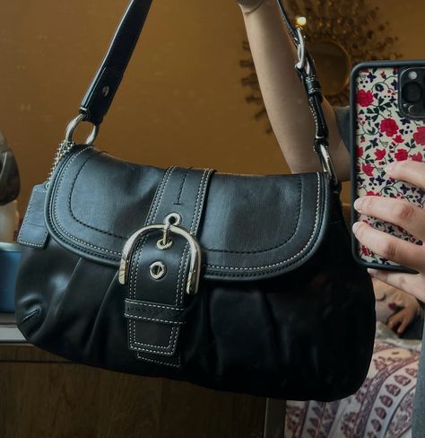 this is the black soho coach shoulder bag it has a buckle in the front and the sides. Buckle Shoulder Bag, Black Satchel Bag Aesthetic, Cute Shoulder Bag Aesthetic, Shoulder Bag Black, Purse Vintage, 90s Designer Bags, Little Black Purse, Coach Soho Shoulder Bag, Shoulder Bag Vintage