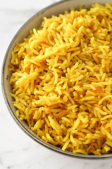 This easy turmeric rice is so full of flavour and makes a great side dish. Turmeric adds lovely colour and cooking in chicken stock makes it the most tastiest rice ever. This yellow basmati rice is oven baked, so you can set and forget while prepping the rest of the meal. Oven Baked Rice, Greek Rice, Basmati Rice Recipes, Turmeric Rice, White Rice Recipes, Side Dishes For Chicken, Baked Rice, Yellow Rice, Peppers Recipes