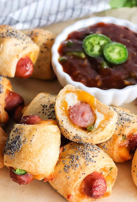 These Jalapeno Popper Pigs in a Blanket are a glorious mash-up of two of our favorite classic appetizers. The savory, smoky cocktail sausages wrapped in buttery crescent roll dough taste amazing with melty cheddar and cream cheese and mildy spicy jalapeno! Perfect for Game Day, parties, and lunches! #pigsinablanket #jalapeno #jalapenopoppers #crescentrolldough #puffpastry #easy #appetizer #gameday #partyfood #semihomemade Popper Pigs In A Blanket, Pigs In A Blanket Recipe, Cocktail Sausages, Cream Cheese Crescent Rolls, Friends Recipes, Jalapeno Recipes, Classic Appetizers, Jalapeno Popper, Best Appetizer Recipes