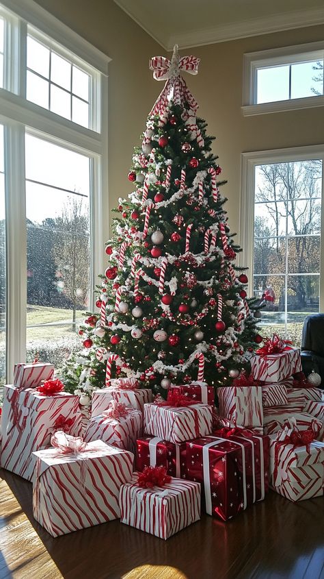 Candy cane-themed Christmas tree with red and white ornaments, surrounded by gifts in a bright, festive room. Gift Under Christmas Tree, Under Christmas Tree Decor Ideas, Christmas Gifts Under Tree, Candy Cane Christmas Theme, Candy Cane Theme Christmas, Gifts Under Christmas Tree, Gifts Under The Christmas Tree, Candy Cane Christmas Decorations, Red And White Christmas Decor