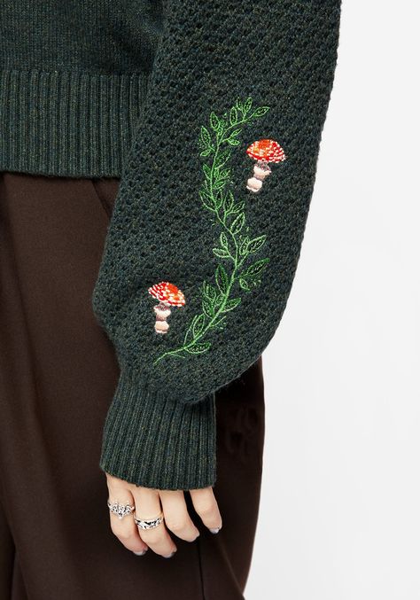 Every fable has its roots- Dark green embroidered knit jumper with mushroom motif - Long-cropped fit with roomy long sleeves - Ribbed crew neckline, cuffs & hems for some cosy insulation - Open knit on sleeves adds textural interest & breathability (good for layering under dramatic trenches) - Soft dark green yarn has a sumptuous hand feel - Whimsical faery mushroom embroidery on body & sleeves - Stretchy knit fabrication for all day warmth & comfort - Goblin academic aesthetic is here! And it’s Mushroom Embroidery, Academic Aesthetic, Embroidered Jumper, Crochet Bookmark Pattern, Clothes Embroidery Diy, Green Yarn, Tailored Jumpsuit, Crochet Bookmarks, Shirt Embroidery