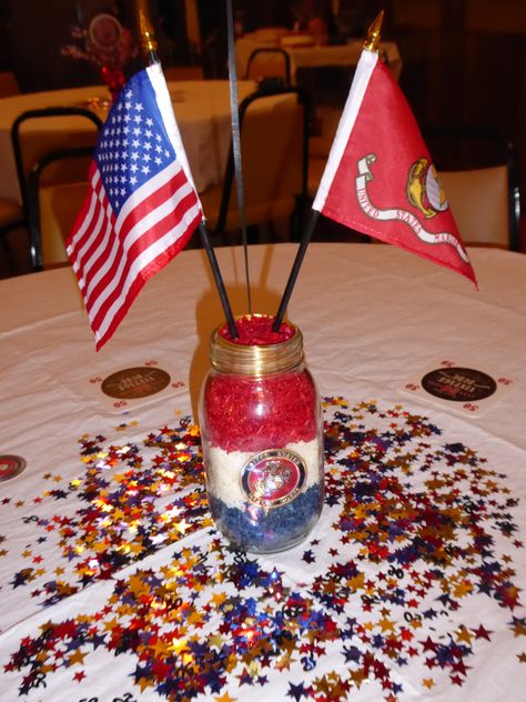 Mason jars (plain, no wording on them) Colored rice (food coloring and vinegar) Pioneer Marine Corps Metal Medallion (Amazon) Gold ribbon (place inside of the top) 4X6 American Flag & Marine Corps flag with black pole and metallic gold top Marine Corps Desserts, Marine Corps Birthday Party, Marine Corps Themed Party, Marine Decorations Party, Marine Centerpieces, Us Navy Centerpiece Ideas, Marine Corps Ball Centerpieces, Marine Party Decorations, Marine Retirement Party Ideas