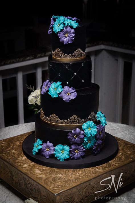 Black and gold buttercream wedding cake with blue and purple sugar flowers by Party Flavors Custom Cakes. Wedding Cake Blue Gold, Super Torte, Purple Wedding Cake, Galaxy Wedding, E Juice, Purple Wedding Cakes, Black Wedding Cakes, Buttercream Wedding Cake, Wedding Cakes Blue