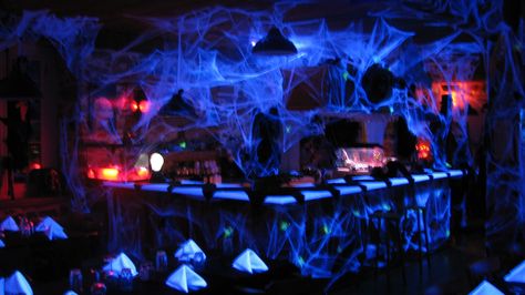 Cobwebs behind bar and by entertainment center Halloween Night Club Decor, Irish Gothic, London Halloween, Halloween Club Party, Haunted Circus, Halloween Party Bar, Halloween Candy Bar, Halloween Club, Halloween Bar