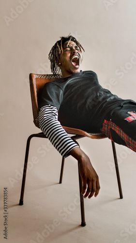 Stock Image: Man on a chair Male Artist Portrait Photography, Street Style Male, Black Street Style, American Male Models, Reference Models, Studio Vibes, Model Studio, Male Portrait Poses, Male Pose