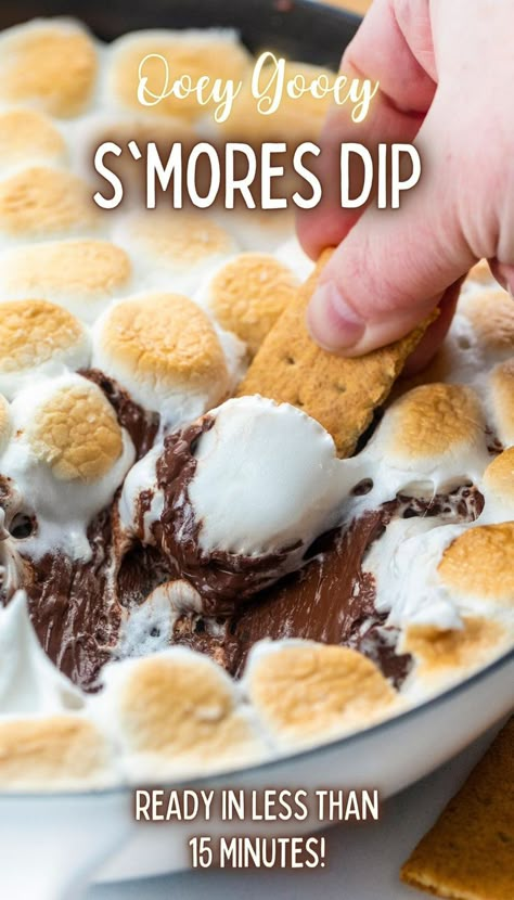 Close-up of a skillet filled with melted chocolate topped with toasted marshmallows and a graham cracker being dipped into it. Smores Dip Recipe, Melted Chocolate Chips, Skillet Desserts, Dessert Dip Recipes, Smores Dip, Smores Dessert, Smore Recipes, Marshmallow Dip, Appetizer Dessert