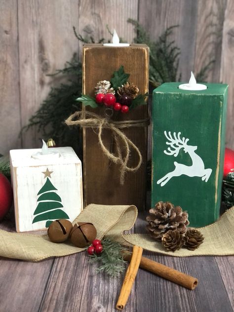 "This set of 3 holiday wood blocks is sure to add a touch of fall vibes to your seasonal decor. The rustic trio of blocks with its varying heights is perfect for an entryway table, fall centerpiece, mantle or on a shelf. These wood blocks would also make great gifts.  Handcrafted using 4x4 wood Dimensions without the LED candles: Large block is 9\" Medium block is 7\" Small block is 3.5\" The LED candles add approx. 1.75\". Dimensions may vary slightly. These solid wood blocks are sanded, painted and slightly distressed. Jute twine and holly berries are added to the large block.  The wood is all hand picked to ensure you are getting the best pieces, but there may be some variations in wood grain, knots, dings, etc., which adds to a unique look. Because each block is handcrafted, no two are Wooden Christmas Candles Diy Wood, Wood Block Presents, Winter Wooden Crafts, Candle Blocks, 4x4 Snowmen Wooden Blocks, Painted Wood Blocks Christmas, Wood Block Decor, Small Wood Block Crafts, Diy Wood Blocks Decor