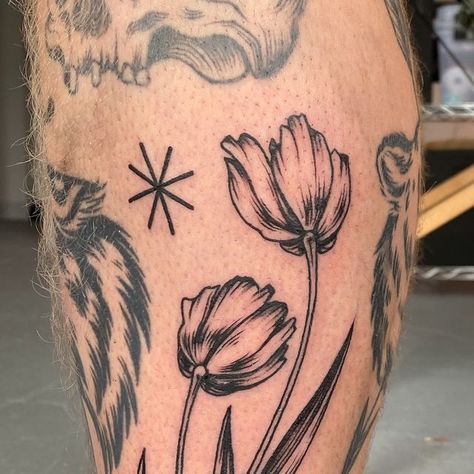 Emily Black • Tattoo Artist on Instagram: "Some tulips I forgot to post! Thank you Scott for getting tattooed again and for trusting me with an extremely questionable sharpie stencil, I had so much fun tattooing these for you 💐" Tulip Leg Tattoo, Tulip Arm Tattoo, Emily Black, Getting Tattooed, Tulip Tattoo, Black Tattoo, Artist On Instagram, I Forgot, Leg Tattoos