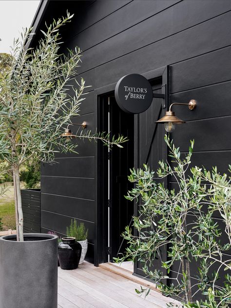 Black House Exterior Landscaping, Modern House Black Exterior, Black Exterior Cottage, Black Magic Exterior House, Black Exterior Cladding, Black House Landscaping Ideas, Black Garden Shed, Black Cottage Exterior, Black Cladding Exterior