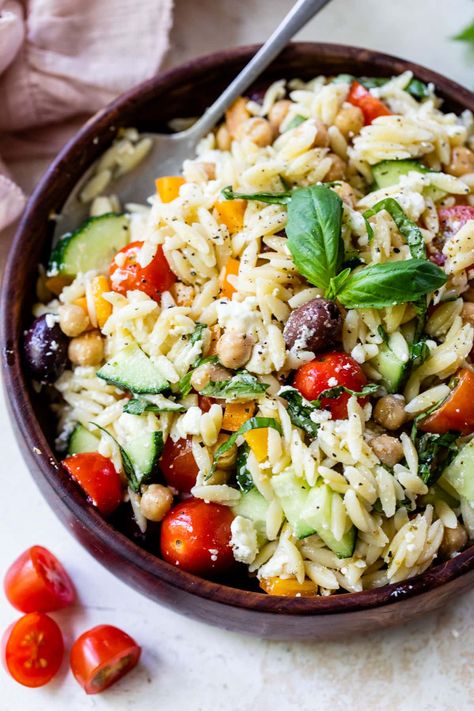 This Greek-inspired orzo pasta salad recipe is loaded with Mediterranean flavor thanks to the feta, olives, chickpeas, and basil. Delish! Orzo Pasta Salad With Chickpeas, Basil Side Dishes, Orzo Salad Dressing, Cold Orzo Salad, Orzo Salad Recipes Cold, Orzo Salad With Chicken, Orzo Dinner, Savory Potato Salad, Orzo Pasta Salad Recipe