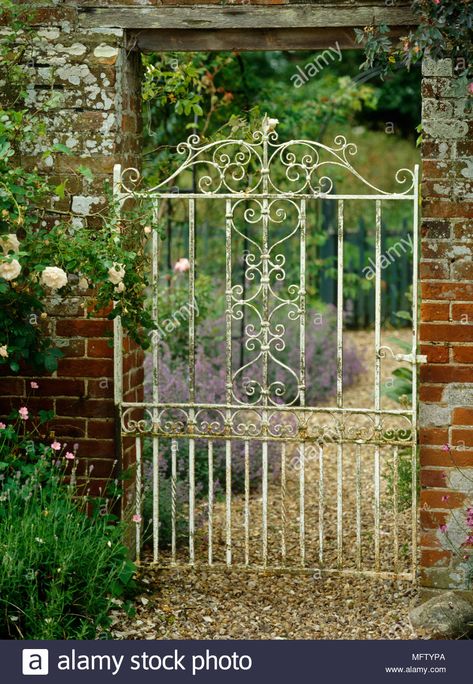 White painted metal garden gate in brick wall Stock Photo Garden Gate Decor, Tor Design, Wrought Iron Garden Gates, Old Gates, Garden Gates And Fencing, Metal Garden Gates, Garden Gate Design, Iron Garden Gates, Gates Design