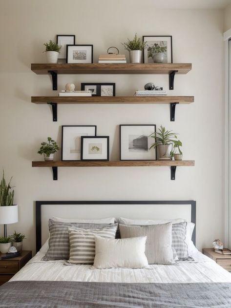 Create a modern and sleek look in your bedroom by arranging three floating shelves above your bed. Use them to display a combination of decorative items and functional storage, like books, plants, and small art pieces, for a stylish and organized space. Bedroom Shelf Decor Above Bed, Bedroom Shelving Ideas Above Bed, Floating Shelves Above Bed, Shelf Decor Above Bed, Small Bedroom Makeover Ideas, Creative Small Bedroom, Budget Bedroom Makeover, Small Bedroom Makeover, Bedroom Wall Decor Above Bed