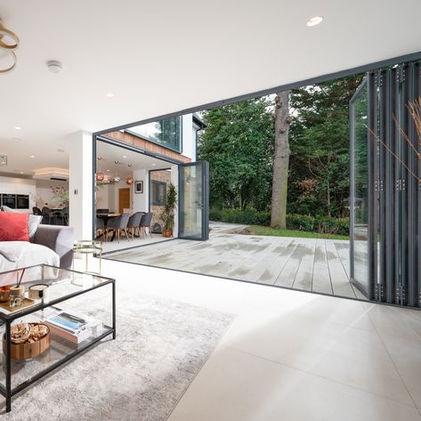 Bifold Doors Onto Patio Garden, White Bifold Doors Onto Patio, Bifold Doors Onto Deck, Black Aluminium Bifold Doors, White Aluminium Bifold Doors, Folding Doors Exterior, Exterior Balcony, Accordion Doors, Laminated Glass