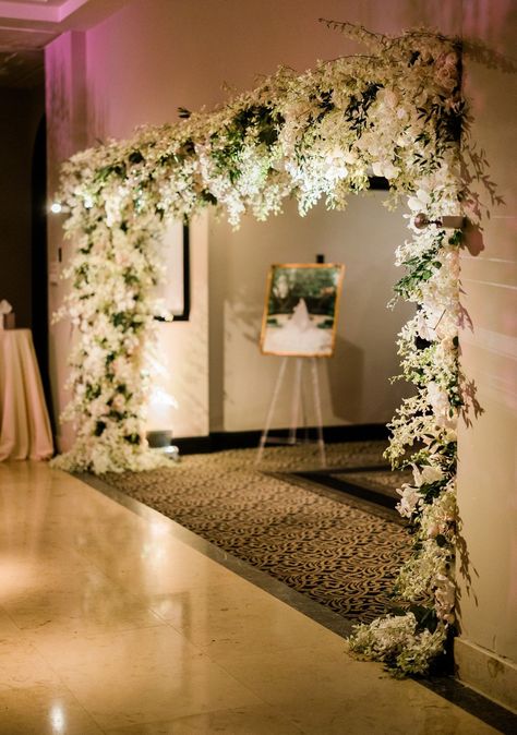 This stunning floral wedding reception entrance with white flowers and greenery wowed guests as they entered the ballroom. To see more of this elegant Houston wedding head to the blog! Elegant Wedding Entrance Decor, Ballroom Entrance Decor, Dramatic Wedding Entrance, Lobby Decor Wedding, White And Green Wedding Entrance, White And Green Decor Wedding, Flower Wedding Entrance, Green Wedding Entrance, Wedding Hall Entrance Decorations