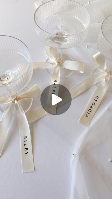 CREO on Instagram: "I’m in loveeee… personalised ribbons 🤍🥂 

Everyone is loving bows and ribbons this season, and I adore this trend for event decor. So I am now offering these gorgeous satin ribbons, with heat pressed vinyl names. 

The ribbons can be used in many ways;
- Place settings / alternatives for place cards
- Bridal party gifts
- Drinks tags
- Wedding bouquet accessories 
- Gift wrapping
- Branding

Shop this particular size and style online now, or contact me to request any custom size and colour scheme 🎀
.
.
.
#weddingstationery #bowseason #personalisedribbon" Name Tags At Wedding, Personalized Ribbon Wedding, Wedding Name Place Cards Ribbon, Bows In Wedding Decor, Ribbon Name Cards Wedding, Bow Wedding Details, Ribbon Place Cards Wedding, Name Place Settings Wedding, Bow Name Place Cards