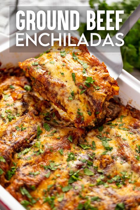 A close up view of a pan of ground beef enchiladas with a red sauce. A spatula is lifting out two of the enchiladas. Homemade Beef Enchiladas, Red Enchiladas Beef, Authentic Enchiladas, Authentic Enchilada Recipe Beef, Beef Enchilada Casserole, Simple Beef Enchilada Recipe, Authentic Beef Enchiladas Mexican Style, Authentic Ground Beef Enchiladas, Mild Enchiladas