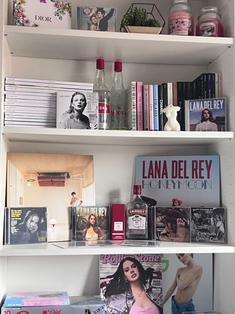 Music Shelf Aesthetic, Coquette Room Shelves, Aesthetic Bedroom Bookshelf, Coquette Bookshelf Aesthetic, Bookshelf Room Aesthetic, Lana Bedroom Aesthetic, Lana Del Rey Dorm Room, Lana Del Rey Aesthetic Room Decor, Aesthetic Bookshelf Bedroom