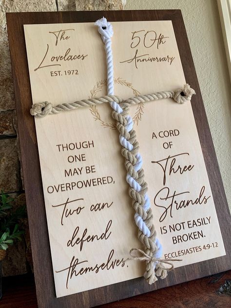 "Our custom engraved \"Cord of three strands\" sign makes a meaningful anniversary gift and keepsake. This item features the last name of the couple, the established year, number of years married as well as the verse \"Though one may be overpowered, two can defend themselves. A cord of three strands is not easily broken.\" This sign features engraved natural wood layered onto a beautifully stained board in the color of your choice. Wall hardware included. *This sign comes in two sizes and is ava 50 Years Of Marriage 50th Wedding Anniversary Vow Renewals, A Cord Of 3 Strands Is Not Easily Broken, Wood Anniversary Gift For Him, Small Country Weddings, Christ Centered Wedding, Beach Bouquet, Sunflower Wedding Decorations, 35th Wedding Anniversary, Cord Of Three Strands