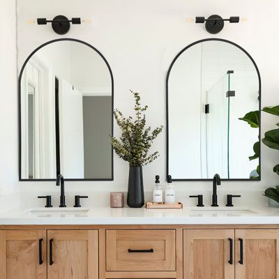 This pair of wall mirrors creates a cohesive look when mounted over the double vanity in your main bathroom. We love the gracefully arched tops that draw the eye upward, giving the illusion of height and spaciousness. Plus, these are more visually pleasing than rectangular or square mirrors. Each has a simple slim frame made from alloy aluminum in a neutral hue and encases a single sheet of mirrored shatterproof glass. These mirrors are designed to be wall mounted and come with installation hard Arched Bathroom, Arched Wall Mirror, Arched Wall, Master Bath Remodel, Bathroom Remodel Designs, Bathroom Inspiration Decor, Upstairs Bathrooms, Bathroom Renos, Bathroom Vanity Mirror