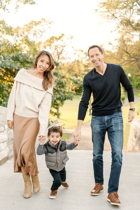 In Northern New Jersey at Verona Park, a mother in a tan skirt and a father in a black sweater help their young son walk by holding his hands by Nicole Hawkins Photography. sweaters for pictures black man sweater cream sweater #nicolehawkinsphotogra Family Wall Gallery, Fall Family Session, Fall Family Portraits, Man Sweater, Lifestyle Images, Tan Skirt, Sweater Cream, Family Wall, Fall Family