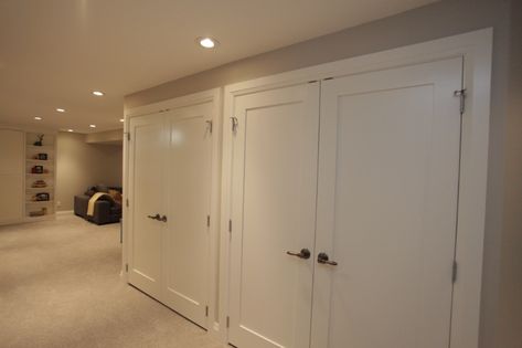 Basement Storage With Doors, Large Basement Closet, Wall Of Closets Basement, Hidden Basement Storage Ideas, Basement Cabinets Storage, Basement Closet Door Ideas, Basement Remodel Small Spaces, Hidden Basement Storage, Basement Closet Storage