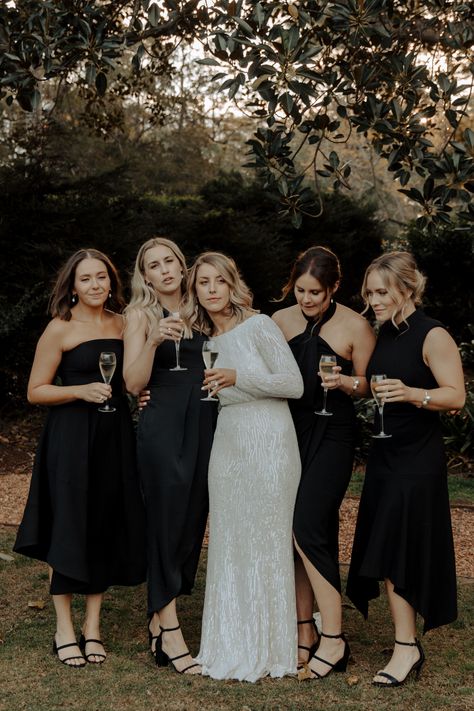 This bridal party was truly having such a fun and playful time. The bride in her stunning sequinned gown was such a beautiful contrast the bridesmaids in their black dresses. The choice to have them in different styles is always such a great choice to have a bit of a personal touch for each bridesmaid to truly feel comfortable. Black Bridesmaid Dress Mismatched, Black Satin Bridesmaid Dress, Chocolate Bridesmaid Dresses, Bridesmaid Dresses Black, Midi Bridesmaid Dress, Black Bridesmaid, Fall Bridesmaid Dresses, Black Bridesmaids, Mismatched Bridesmaid Dresses