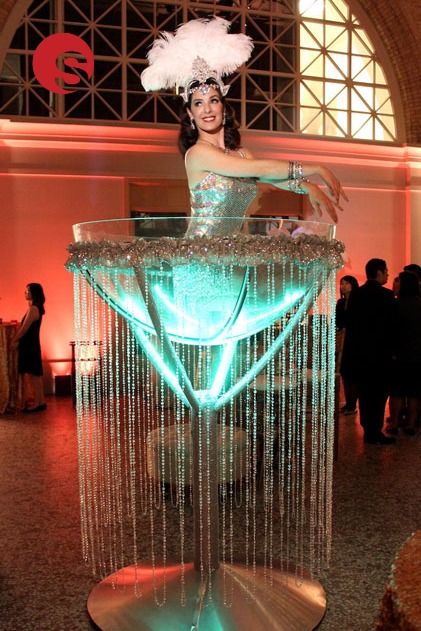 Our giant martini glass is the one of most glamorous entertainment options for your James Bond themed party! Our martini glass burlesque performer is part living décor and installation art. The enormous martini glass can be used for a glamorous entranceway, bar centrepiece, focal point and as interactive entertainment to ensure your guests have the time of their lives at your event! Circus Theme Party Adults, Burlesque Party Decorations, Burlesque Theme Party, Burlesque Theme, Christmas Entertainment, Burlesque Party, James Bond Party, Burlesque Costumes, Vegas Party