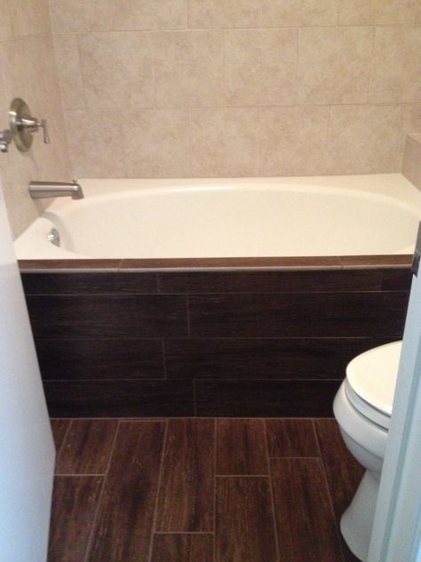 Dark walnut wood tile floor and bathtub face. Contrast with Rialto white tile bathtub surround. Tile Bathroom Design, Remodeling Furniture, Ceramic Wood Tile Floor, Wood Tile Floor, Bathroom Facelift, Tile Bathtub, Wood Tile Shower, Walnut Bathroom, Bathroom Dark