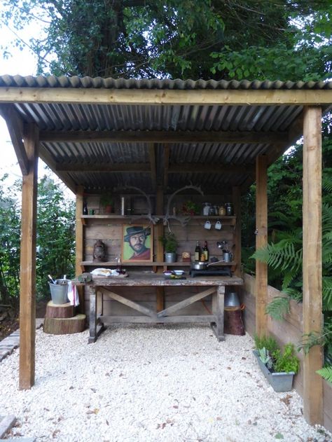 An outdoor kitchen for my man... love the painting of Clint!  Jacob Cottage UK Grill Patio, Bbq Shed, Rustic Outdoor Kitchens, Diy Outdoor Bar, Outdoor Kitchen Bars, Backyard Bar, Wooden Structure, Building Tips, Bbq Area