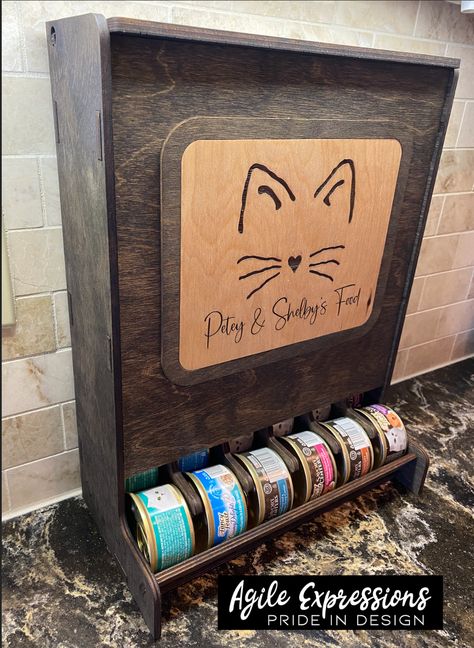 I could not find a suitable storage solution for my fur babies' canned food, so I made one! 😸 Custom pet food dispenser for 3oz or 5.1/5.5oz cans made from 1/4" birch, hand finished with stain and Odie's Oil to protect the pieces. Custom made for 3 oz. or 5.1/5.5 oz. canned food: 3 oz. size Fits 36 - 3 oz. cans: 15.25" x 6.25" x 11.50" 5.1/5.5 oz. size fits 30 - 5.5 oz. cans: 15.4" x 8" x 12.5" Please be sure to enter your desired text in the order notes box when checking out if choosing the "s Wet Cat Food Storage, Cat Food Container Ideas, Cat Food Can Storage, Canned Cat Food Storage Ideas, Cat Food Organization, Wood Dog Food Storage, Pet Storage Ideas, Pet Supply Storage, Pet Food Storage Ideas