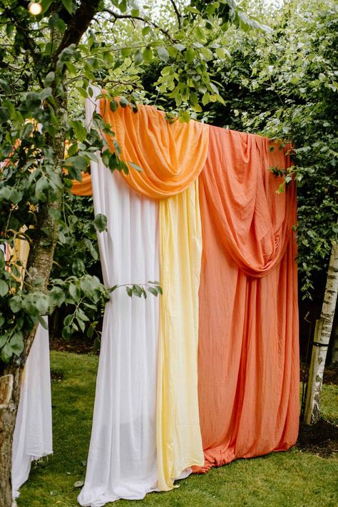 Diy Backdrop Ideas, Mehndi Celebration, Drape Backdrop, Orange Drapes, Lantern With Fairy Lights, Colorful Backdrop, Modern Mehndi, Draping Wedding, Cradle Ceremony