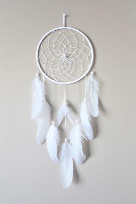 White Feather Dream Catcher with a web weave center.  It has lots of beautiful fluffy white goose feathers. This is a very simple yet elegant piece and would be the perfect addition to a boho style room or even make a great gift! CUSTOMIZE - we are happy to add a pop of color so please don't hesitate to ask questions. We carry a wide range of colored feathers.  Approximate Measurements:  Hoop: 7"  23" length Please hang away from direct sunlight. Cloud Dream Catcher, Teen Room Decor Small Rooms, Kids Dream Catcher, Simple Dreamcatcher, Dream Catcher Ideas, Dream Catcher Painting, Boho Bedroom Wall Decor, White Dream Catcher, Boho Style Room