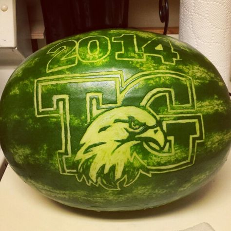 Graduation watermelon carving by Kira Smith Graduation Watermelon, Mustang Mascot, Carved Watermelon, Platter Display, Veggie Art, Fruit Ideas, Watermelon Carving, Food Sculpture, Luau Theme