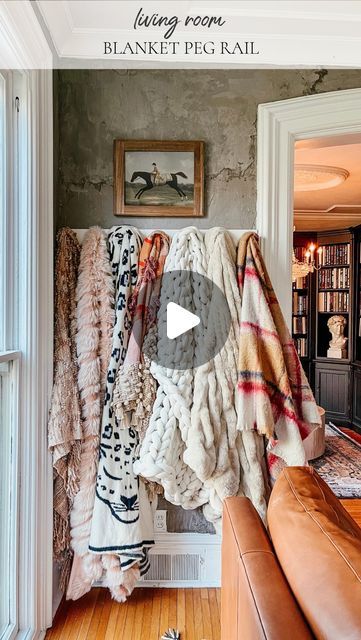 Susan on Instagram: "If you ask me, some blankets and throws are just too beautiful for a cabinet. They’re actual art. Do you agree?! All it took was a peg rail and now we can enjoy these cozy blankets on display even when we aren’t snuggled up in them! Follow for more simple ideas to make your home extra cozy! Search Kindredvintage on @shop.ltk for links ◡̈ #anthropologie #arhausinmyhouse #anthroliving #diy #cozyhome #blankets #pegboard #homedecor" Hanging Throw Blankets On Wall, Hanging Blankets On Wall Hooks Living Room, Style Throw Blanket Couch, Blankets On Couch Ideas, Blanket On Couch, Blanket Tapestry Wall Hangings, Throw Blanket On Couch Chase, Blanket Draped On Couch, Blanket Display Ideas