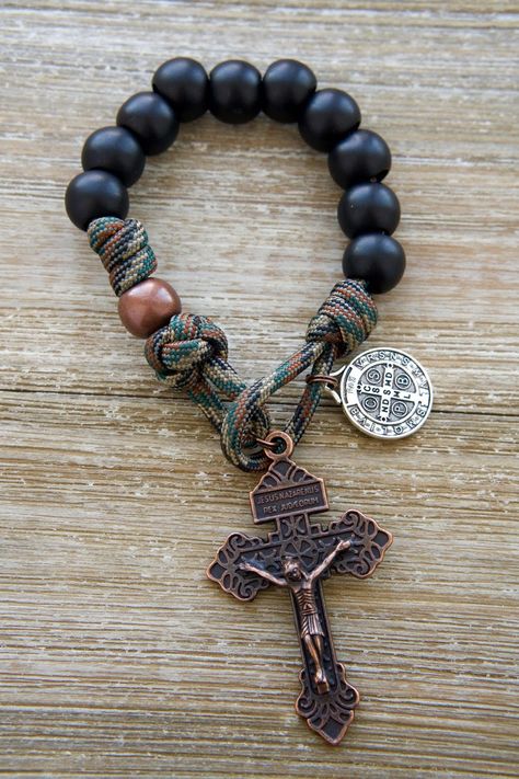 Introducing "The Serpent Slayer" Pocket Paracord Rosary: The Ultimate Weapon Against Evil!This powerful rosary features matte black Hail Mary beads and an antique copper Our Father bead, creating a bold and masculine look that exudes strength and determination. The striking combination of colors serves as a constant reminder of your unwavering devotion to God and your commitment to combat evil in all its forms.But "The Serpent Slayer" isn't just about looks – it's also a spiritual powerhouse, fe Mens Rosary, Paracord Rosary, St Benedict Medal, Expensive Stones, Iphone Wallpaper For Guys, Android Wallpaper Art, Benedict Medal, Slide Bracelet, The Serpent