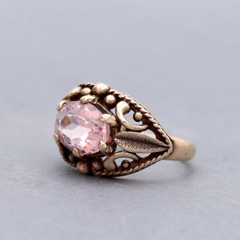 A sensuous Late Victorian gold ring is set with an oval Morganite. The petal-pink Morganite Beryl(a new addition to the ring) weighs 1.73 cts and is set "east-west" atop the open work dome of this lovely ring. The contours of the ring has it fitting as 4.75. Resizing may be possible, please inquire. The ring is an antique original from the early 20th Century. 10K gold. Stamped with the maker's mark "JA". #leighjayandco #antiquejewelry #antiquejewelryforsale #artdecojewelry  #antiquejewelryad... Victorian Pink Oval Rings, Victorian Jewelry With Rose Cut Diamonds In Oval Shape, Antique Pink Ruby Ring With Rose Cut Diamonds, Victorian Oval Garnet Ruby Ring, Pink Victorian Hallmarked Ruby Ring, Victorian Gold Ring, Antique Locket, Jewelry Ads, Victorian Gold