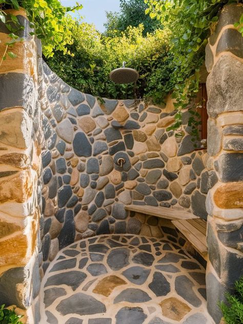 21 DIY Outdoor Shower Ideas – The DIY Desire Spiral Outdoor Shower Ideas, Camp Bathroom Ideas, Out Door Shower, Outdoor Shower With Stone Wall, Outdoor Shower Stone, Mountain Outdoor Shower Ideas, Outdoor Shower Ideas, Outdoor Shower With Pebble Floor, Outdoor Shower Ideas Backyards