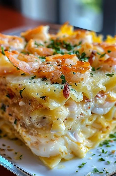 Savor layers of rich Shrimp Scampi Lasagna packed with garlic, lemon, and creamy cheese. Perfect for seafood lovers! #SeafoodLasagna #ShrimpScampi #ComfortFood #PastaDelight #ItalianCuisine Lemon Seafood Pasta, Shrimp Scampi Lasagna, Shrimp Lasagna Recipe, Shrimp Alfredo Bake, Baked Seafood Casserole, Seafood Lasagna Recipe, Shrimp Lasagna, Seafood Pasta Bake, Creamy Garlic Prawns