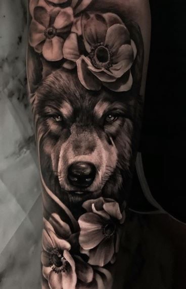 Wolf Tattoos - What's their Meaning? PLUS Ideas & Photos Half Sleeve Tattoos Wolf, Best Rose Tattoo, Grey Wolf Tattoo, White Wolf Tattoo, Wolf Girl Tattoos, Lone Wolf Tattoo, Husky Tattoo, Wolf Tattoos For Women, Wolf Sleeve