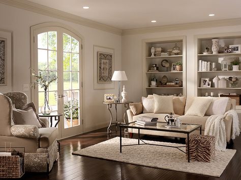 We love the look of lighter white walls with darker white trim. Add in neutral furniture and dark wood floors and you have a cozy living room space.  Walls: Cotton Knit UL170-13 Ceiling: Silky White UL170-12 Trim: Roman Plaster UL170-11 Alcoves inside: Parachute Silk UL160-16 Hallway Paint Colors, Behr Paint Colors, Bitter Chocolate, Behr Paint, Room Paint Colors, Paint Colors For Living Room, Living Room Colors, A Living Room, Living Room Paint