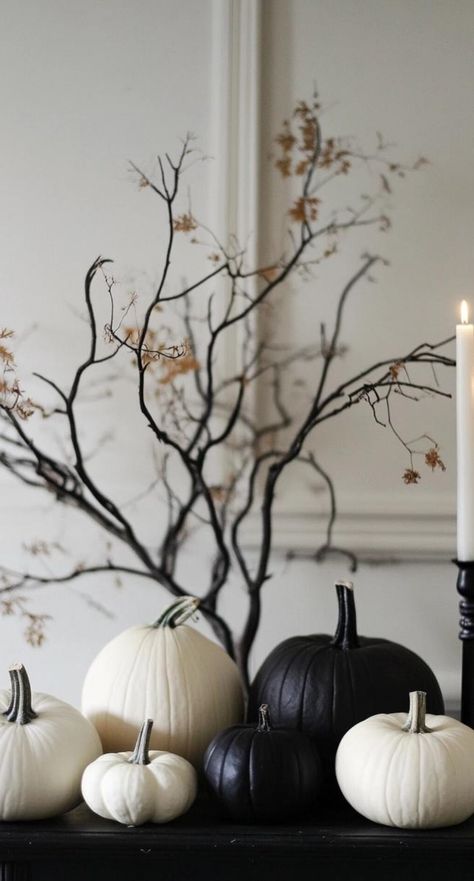 Embrace the essence of Halloween with minimalist decor that speaks volumes through simplicity. Opt for a monochromatic palette of black and white, punctuated by subtle orange accents. Arrange sleek, unadorned pumpkins in varying sizes for a striking visual impact. Incorporate clean-lined silhouettes of bats or ghosts cut from matte black paper. Let negative space work its magic, creating an atmosphere that's both eerie and elegant. This minimalist approach to Halloween decor proves that less can Halloween Decorations Outdoor Minimalist, Halloween Home Decor Minimalist, Halloween Fancy Decor, Modern Halloween Party Decor, Simple Modern Halloween Decor, Neutral Halloween Decor Front Porch, Black White Halloween Decor, Black And Silver Halloween Decor, Halloween Minimalist Decor