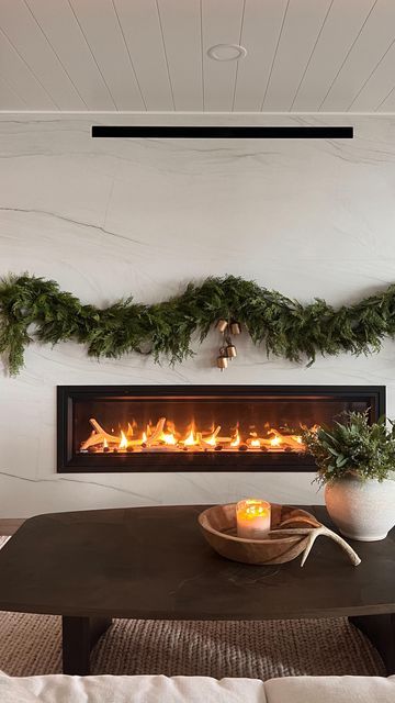 Jennifer Virkus on Instagram: "No Mantle, No Problem! (Comment SHOP for links) Command hooks to the rescue! I used a combination of different hooks and bundle cords to create a “no mantle” fireplace garland moment at the lake house. WHAT I USED: I used 2 (6ft) cedar garlands on each side for a total of 4 garland strands. I stacked them on one another to create a fuller look and secured them with bundle cords and smaller hooks. In true Jenny fashion I just added bells and called it good. For me personally, less is always more 🤍 My garland and bells are from McGee & Co . MHH10 saves you 10% on your order of $100 or more 🤍 HOW TO SHOP- Comment SHOP or tap the link in my Bio to shop my home via the LTK app #fireplacedecor #christmasmantle #modernfireplace" Garland On Electric Fireplace, No Mantle Fireplace Decor Christmas, Garland No Mantle, Christmas Fireplace No Mantle, Fireplace With No Mantle Christmas, Garland With No Mantel, Garland On Fireplace Without Mantle, Christmas Fireplace Without Mantle, Christmas Decor No Mantle