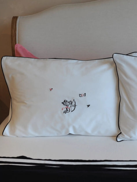 This luxe pillow case set is ethically crafted from buttery soft cotton sateen in a classic white shade. Design in collaboration with illustrator Olivia Sewell, it features a cherub design in pink with black details and trim. 
Elevate their everyday with luxurious personalised bedding. Inspired by boutique hotel stays and dreamy holiday destinations, each personalised bedding set is sustainably designed and crafted from premium cotton sateen for tasteful and considered gifting.
cute core Cherub Design, Destination Wedding Gifts, Libra Gifts, Shade Design, Wine Candles, Wedding Gift Guide, Luxurious Bedding, Personalized Newborn, Cute Core