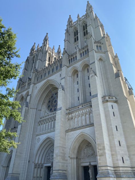 The two towers of the white stone Washington National Cathedral, with arched entry doors and a round stained glass window Washington Cathedral, Broken Windows, Washington National Cathedral, National Cathedral, Trip Aesthetic, Gold Reserve, Ny Trip, Broken Window, Washington Usa