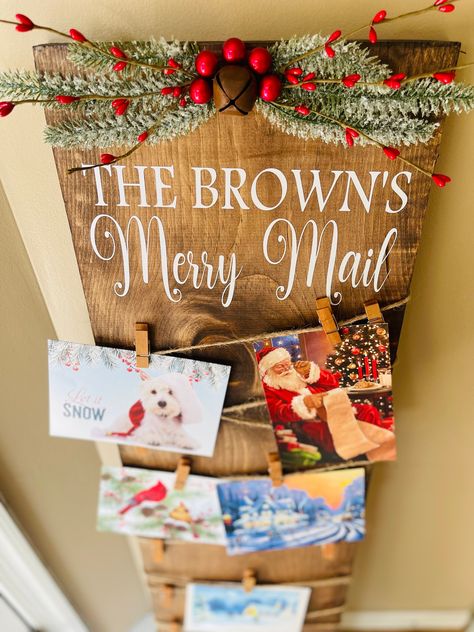 Merry Mail, farmhouse, advent, Christmas, holiday, rustic, merry, display, family, personalized, card, holder, photo, mail merry mail family wood hanging sign. This sign is a great way to display your beautiful Christmas cards! Choose between a background of white, gray, red, or old weathered brown wood the handles may be different than you see in main picture. I add them As I have what available. SIZE OF THE BOARD IS 24 INCHES TALL AND 12 INCHES WIDE. Sign may vary slightly from the one pictured. I make no attempts to cover up knots and other imperfections in the wood that give it character. *Clothespins not included* Paper clips and binder clips work as well to hold cards onto the sign. SHIPPING: This item is packaged in bubble wrap and brown paper. If you USPS looses or damages the item Christmas Card Board Display, Merry Mail Card Holder Diy, Rustic Christmas Signs Diy, Cute Ways To Display Christmas Cards, Merry Mail Wood Sign, Ways To Hang Christmas Cards, Christmas Cards Display Ideas, How To Display Christmas Cards, Christmas Card Holder Ideas