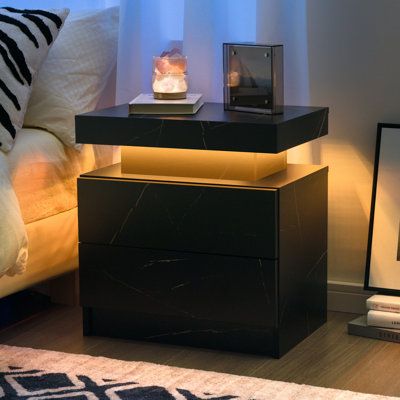 Specification: Product name: LED Beside the table. Material: MDF, LED light. Color: White. Weight Capacity: 66lb. Product Size: 19.3*13.7*20.5 in. Package Included: 1Pcs*LED beside table, 1pcs*instruction. Color: Black Marble | Ivy Bronx Bedside Table w / 2 Drawers, Led Nightstand Wooden Cabinet Unit w / Led Lights For Bedroom | 20.5 H x 19.3 W x 13.7 D in | Wayfair Bedside Table With Lamp, Modern End Tables For Bedroom, Bed Stands Bedside Tables, His And Hers Nightstands, Men Apartment Decor Bedroom, Side Table For Bedroom, Modern Home Decor Bedroom, Black Bedside Table Ideas, Mens Home Decor