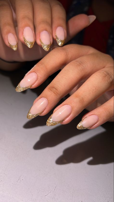 Golden Glitter French Tip Nails, Nail Ideas Gold Glitter, December Nails New Years, Gold Glitter Tips Acrylic Nails, Gold Glitter Tip Nails French, Gold Tip Nails Almond, Golden Tips Nails, Gold Sparkle French Tip Nails Almond, Gold Glitter Tips Nails